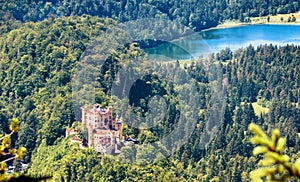 Hohenschwangau castle and Schwansee lake in Bavarian Alps, Germany. Beautiful landscape of Alpine mountain with famous castle in