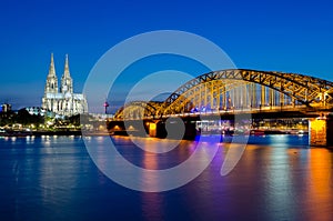Hohenzollern bridge with t Cologne Cathedral and Rhine river during sunset in Cologne, Germany. Europe tourism, history building,