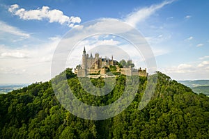 Hohenzollern Castle on forested mountain top in the Swabian Alps in summer