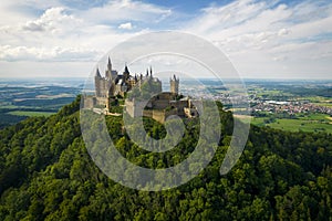 Hohenzollern Castle on forested mountain top in the Swabian Alps in summer