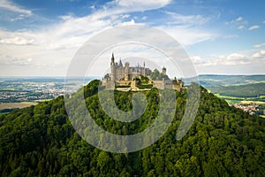 Hohenzollern Castle on forested mountain top in the Swabian Alps in summer