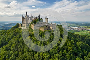 Hohenzollern Castle on forested mountain top in the Swabian Alps in summer