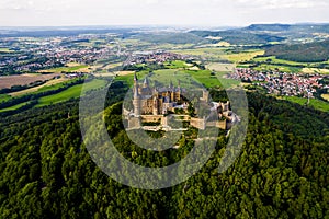 Hohenzollern Castle on forested mountain top in the Swabian Alps in summer