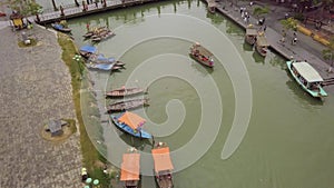 Hoi An channel landscape motorboat sails to footbridge