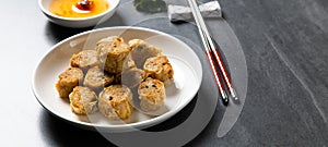 Hoi Jo or Hai Choe Deep Fried Crab Meat Rolls. Chinese Traditional cuisine concept. Dumplings Dim Sum in bamboo steamer with