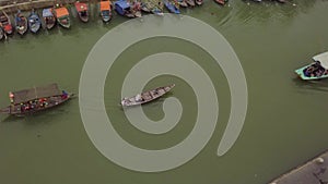 Hoi An river landscape motorboat and traditional vessel