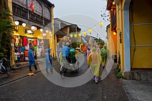 A crowded market street at dusk in the old heritage town of Hoi An in Vietnam