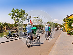 HOIAN, VIETNAM, SEPTEMBER, 04 2017: Unidentified people biking and walking in the streets in Hoi An ancient town, UNESCO