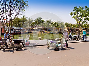 HOIAN, VIETNAM, SEPTEMBER, 04 2017: Unidentified people biking and walking in the streets in Hoi An ancient town, UNESCO