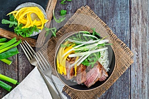 Hoisin duck with mango, spring onion, rocket lettuce salad and rice