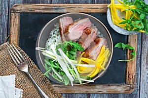 Hoisin duck with mango, spring onion, rocket lettuce salad and rice