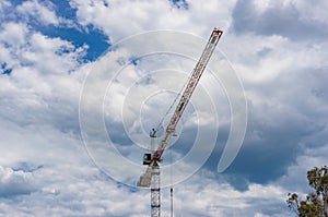Hoisting crane against sky on the background
