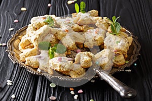 Hojarascas Traditional Mexican Shortbread Cookies with pecans, anise, zest and mint close-up. horizontal photo