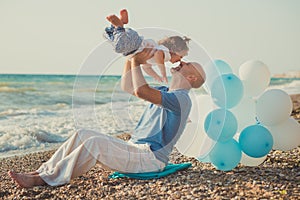 Hokum tender scene of handsome bolt happy father enjoy life time summer vacation with his little baby girl daughter on sand beach.