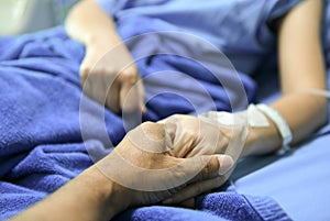 Hold hands to encourage the patient