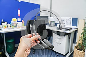 Hold headset in callcenter office for business company