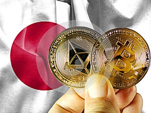 Hold the physical version of Bitcoin (the new virtual currency) and the Japanese flag