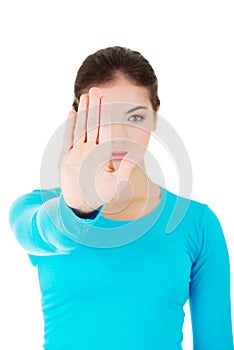 Hold on, Stop gesture showed by young woman