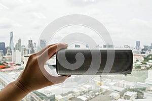 Hold wireless bluetooth speaker with left hand