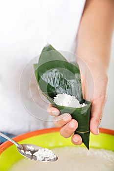 Hold the zong leaves with both hands into a funnel shape and prepare to make zongzi