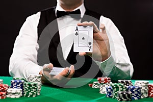 Holdem dealer with playing cards and casino chips