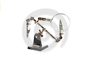 holder with clamps and magnifying glass for soldering,  on white background