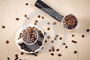 holder for coffee maker, cup and scattered beans/ holder for coffee maker, cup and scattered beans on stone background. Top view