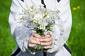 Holding bouquet of wild flowers