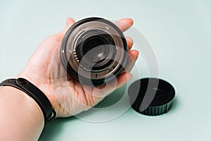 Holding Camera Lens Showing Rear Element and Mount