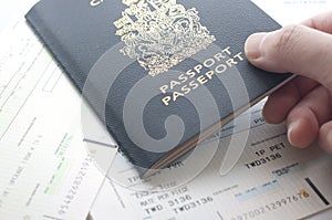 Holding Canada passport with boarding pass