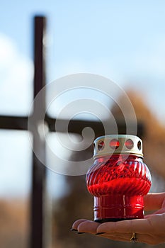 Holding a candle at cemetery