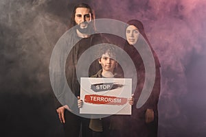 Holding card with stop terrorism lettering