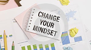 holding a card with text CHANGE YOUR MINDSET. Diagram and white background