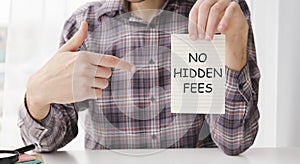 holding a card with text NO HIDDEN FEES