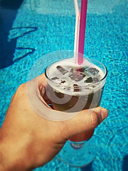 Holding cocktail in the pool