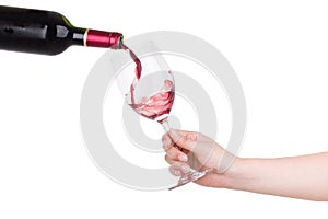 Holding a cup of red wine pour isolated on white