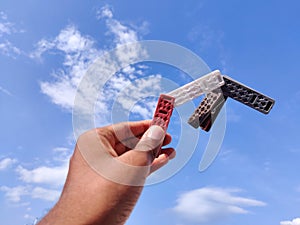 holding four different color clothespin or cloth clip.