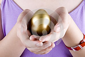 Holding a golden egg