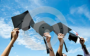 Holding graduation hats photo