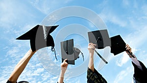 Holding graduation hats photo