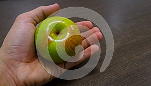 Holding a green apple