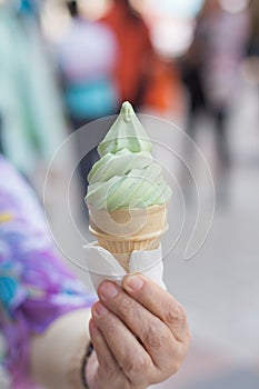 Holding green tea ice-cream cone