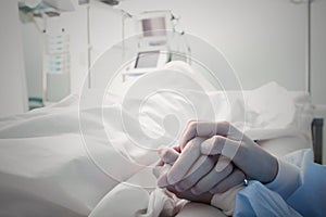 Holding the hand of a dying man photo