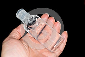 Holding a hand sanitiser bottle. To prevent and protect against germs, virus and bacteria.