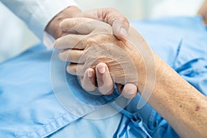 Holding hands Asian senior or elderly old lady woman patient with love, care, encourage and empathy at nursing hospital ward,