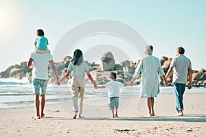 Holding hands, beach and rear view of big family walking at the sea, fun and travel on blue sky background. Behind, love