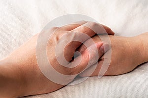 Holding hands in bed