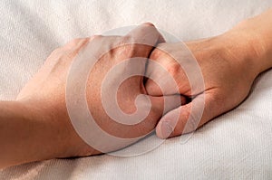 Holding hands in bed photo