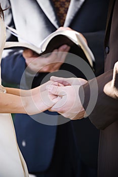 Holding hands at the ceremony photo