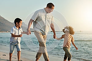 Holding hands, children and grandfather walking on beach, having fun or bonding outdoors. Love, care and happy grandpa